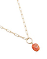 Faceted Coral in the shape of an Oval Hangs From a Gold Ring and Matte Gold Paperclip Chain Necklace. Close up view of Coral and Ring. Side View.