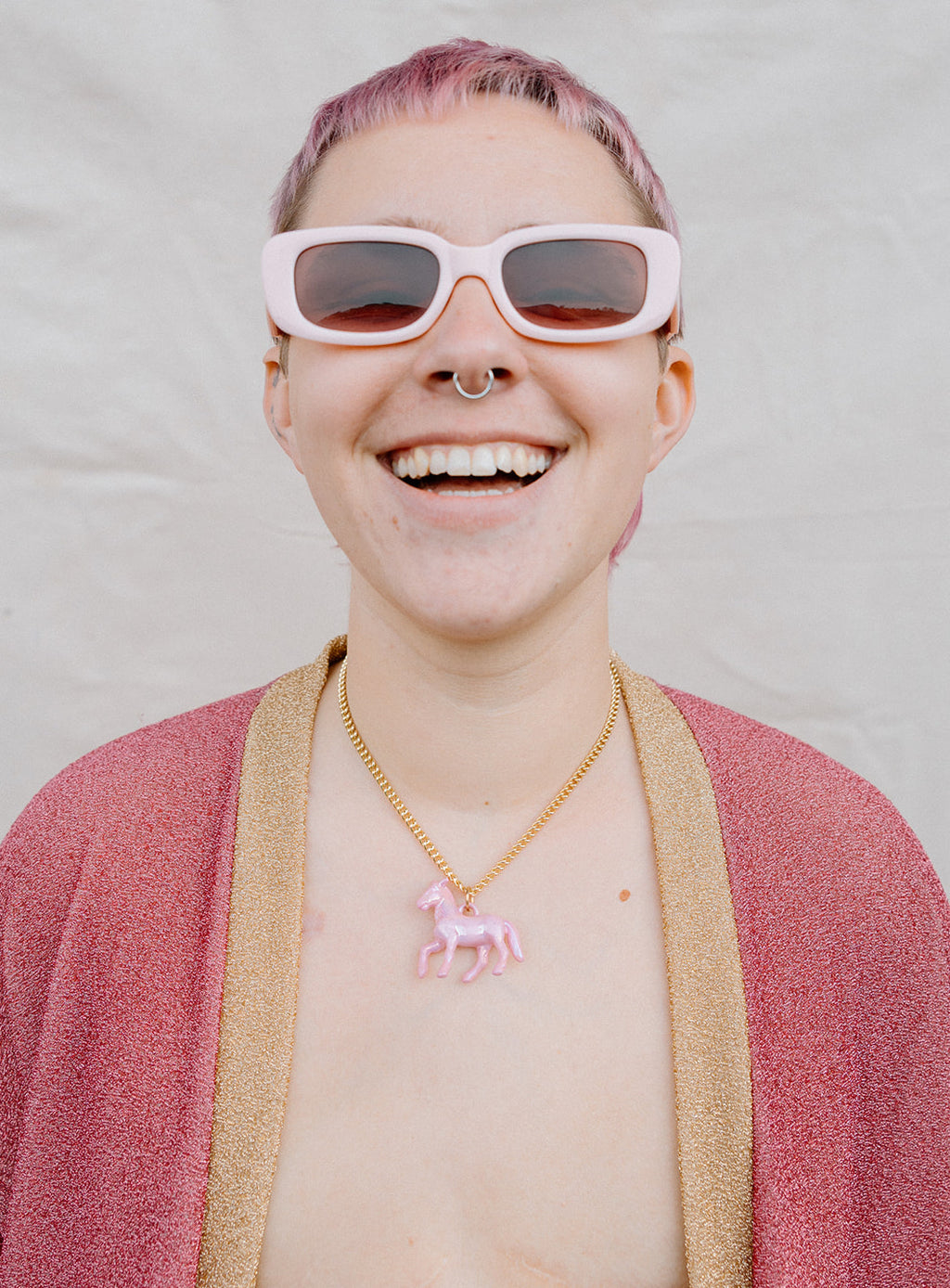 Model Wearing a Pink Pony Pendant Necklace With Gold Chain