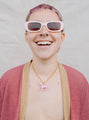 Model Wearing a Pink Pony Pendant Necklace With Gold Chain