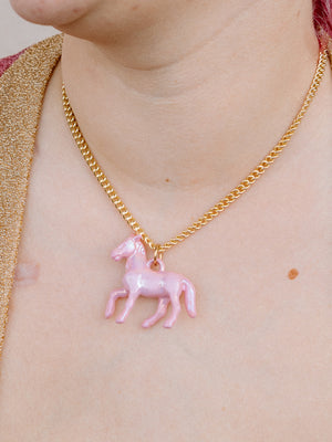 Closer Up Image of Model Wearing Pink Pony Pendant Necklace With Gold Chain