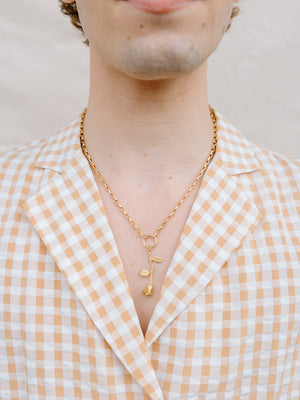 Closer Up Image of Model Wearing Golden Rose Necklace With Gold Ring and Chain