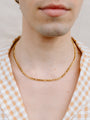 Closer Up Image of Model Wearing Gold Figaro Chain Necklace