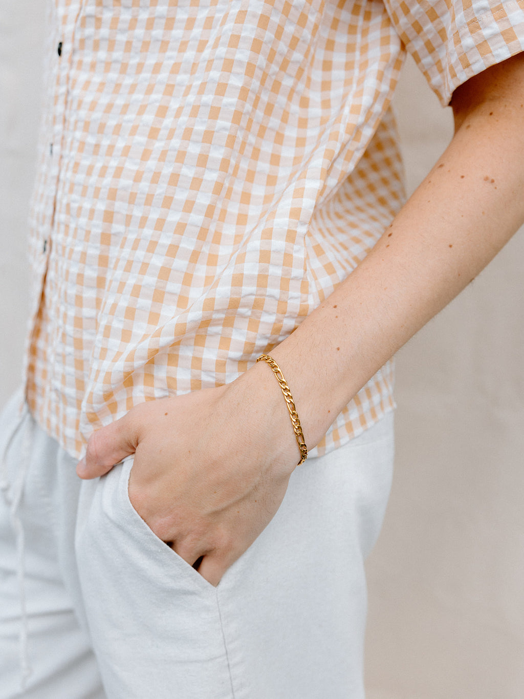 Model Wearing Gold Figaro Chain Bracelet