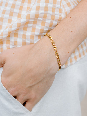 Closer Up Image of Model Wearing Gold Figaro Chain Bracelet