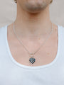 Closer Up Image of Model Wearing Checker Board Heart Necklace With Silver Ring and Figaro Chain