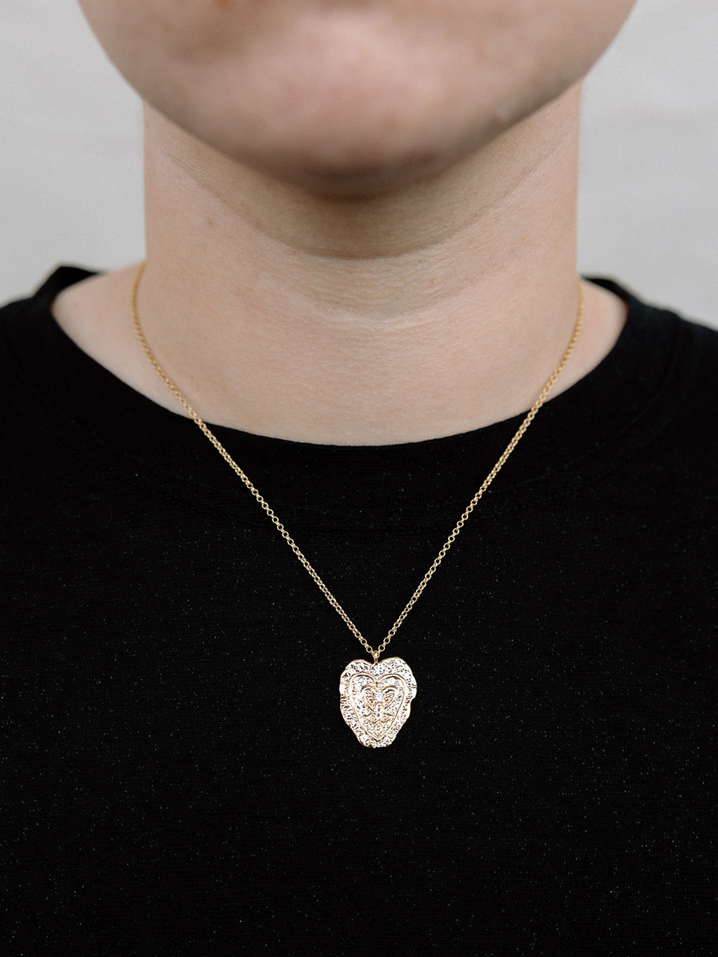 Model Wearing Gold Heart Necklace With Small Gold Rolo Chain