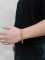 Closer Up Image of Model Wearing Shiny Gold Plated Snake Chain Bracelet