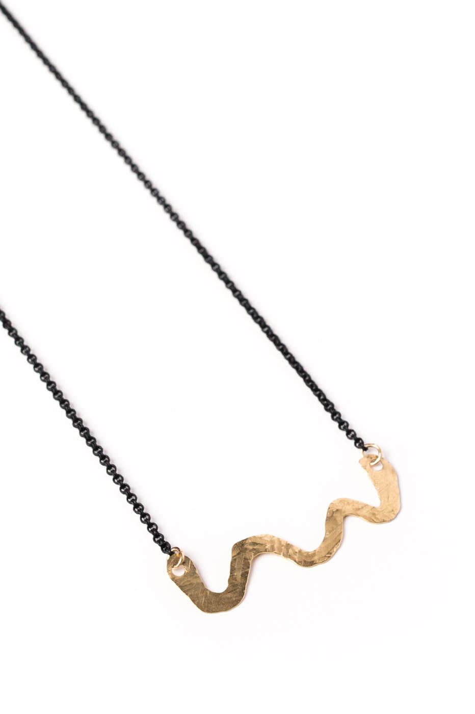 Hand Forged Brass Swiggle Necklace on a Black Chain (closeup)