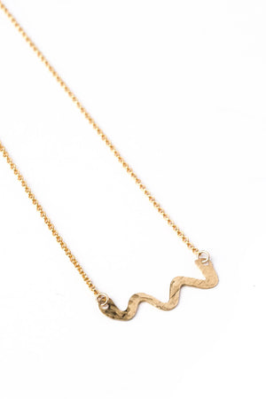 Hand Forged Brass Swiggle Necklace on a Gold Chain (closeup)